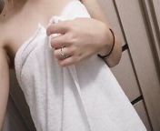 Home striptease after a shower in a white towel. Close-up from after bath towel aunty going room