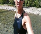 Swimming in mountain river in clothes - sneakers, shorts and t-shirt from hijabi shemale removing clothes showing boobs and pussy
