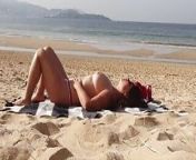 ExpressiaGirl with big tits sunbathes and walks naked on the beach from nudist summer